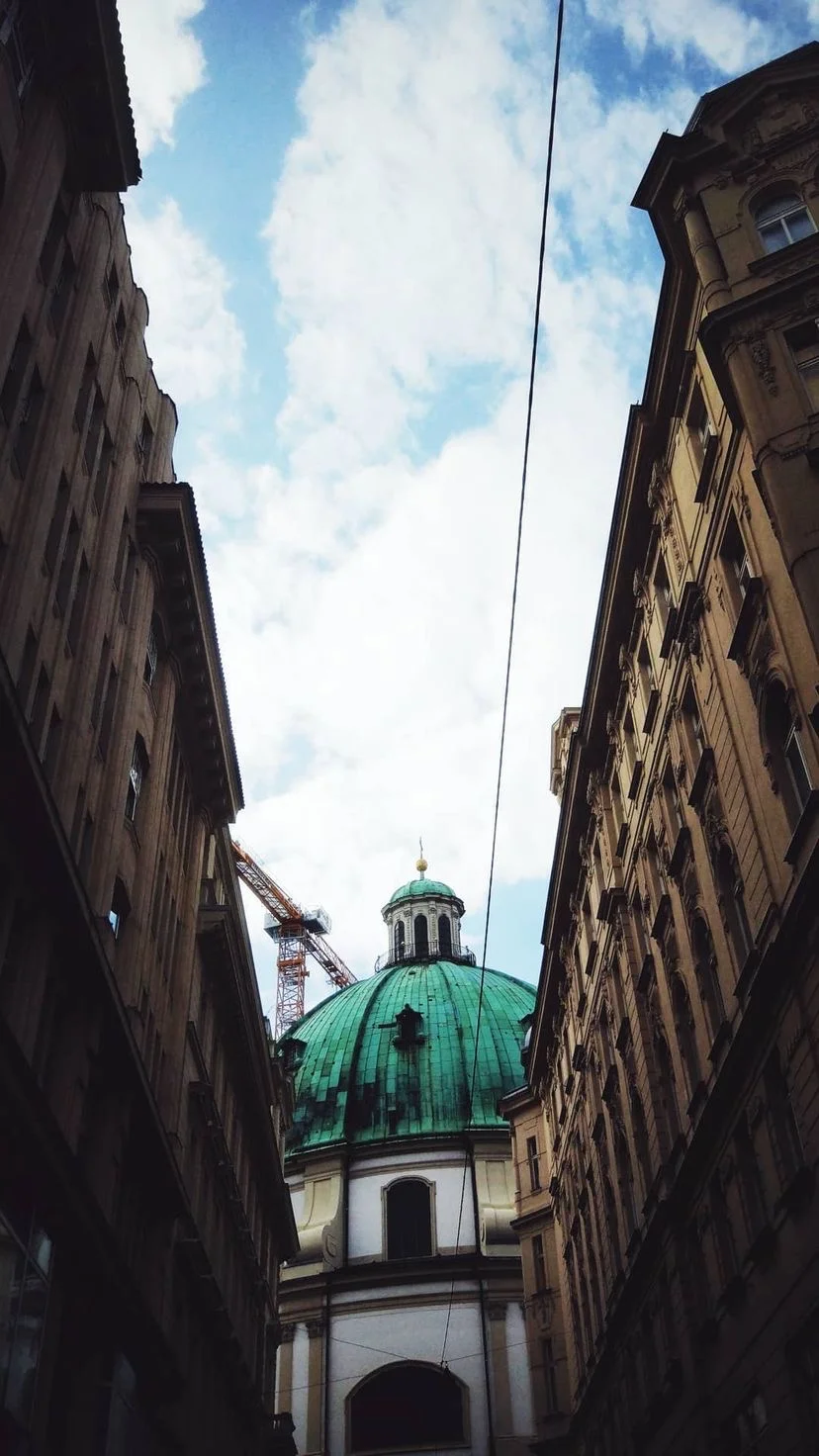 Narrow street leading toward a green dome, W:9 H:16, photograph 60