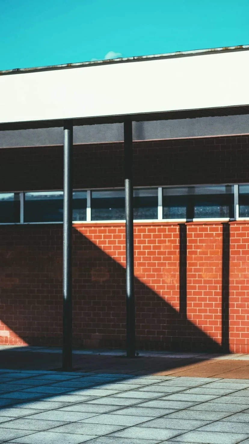 Hard sunlight and diagonal shadows on a red brick facade, W:9 H:16, photograph 62