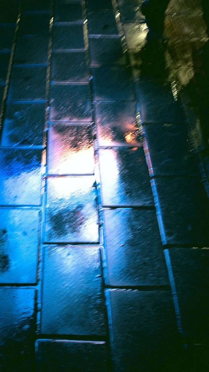 Blue and white light reflected on wet pavement, W:9 H:16, photograph 51