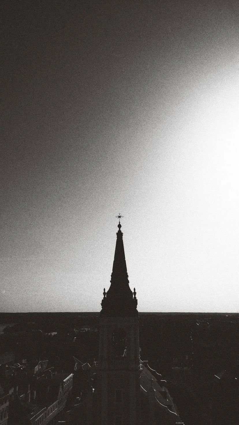 A distant spire in a black and white cityscape, W:9 H:16, photograph 23